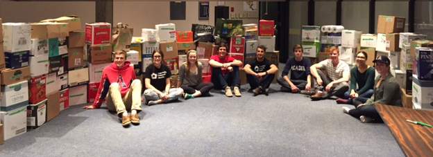 Acadia students with boxes of food from 2016 Trick or Eat Food Drive.